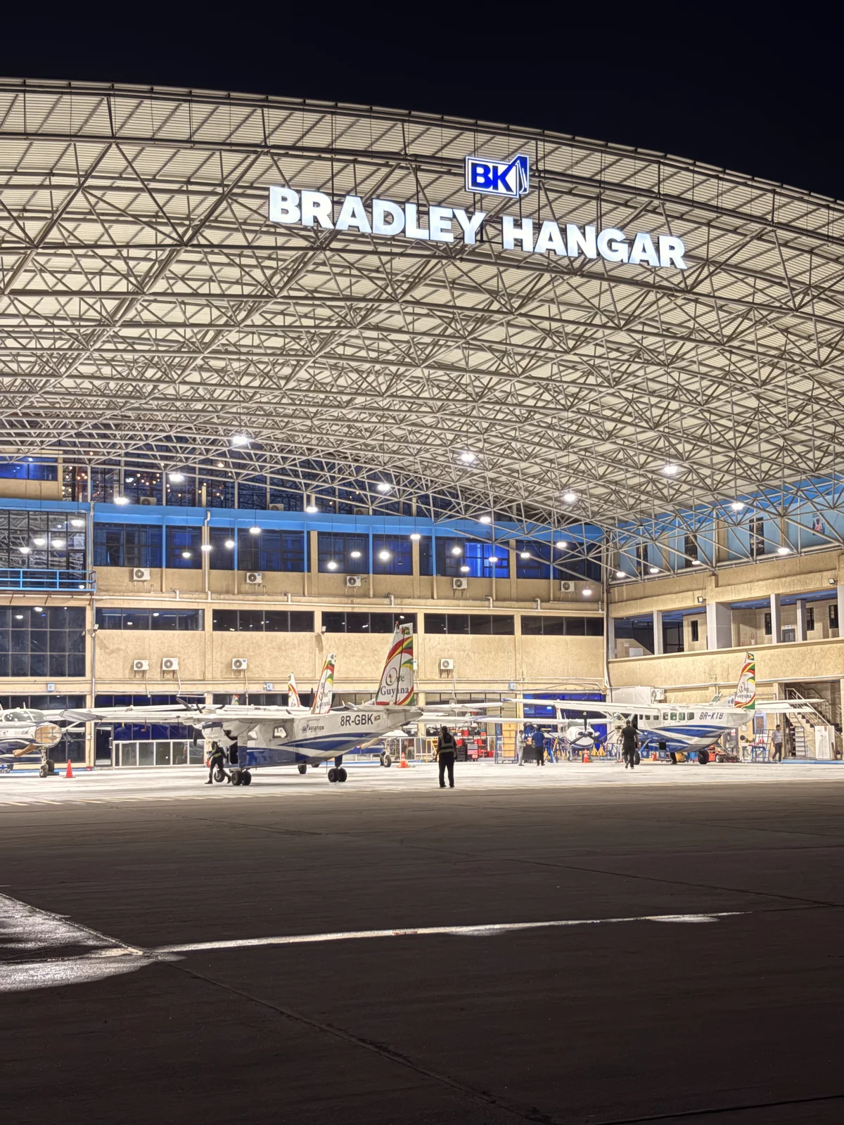 Aircraft inside the illuminated Bradley Hangar at night