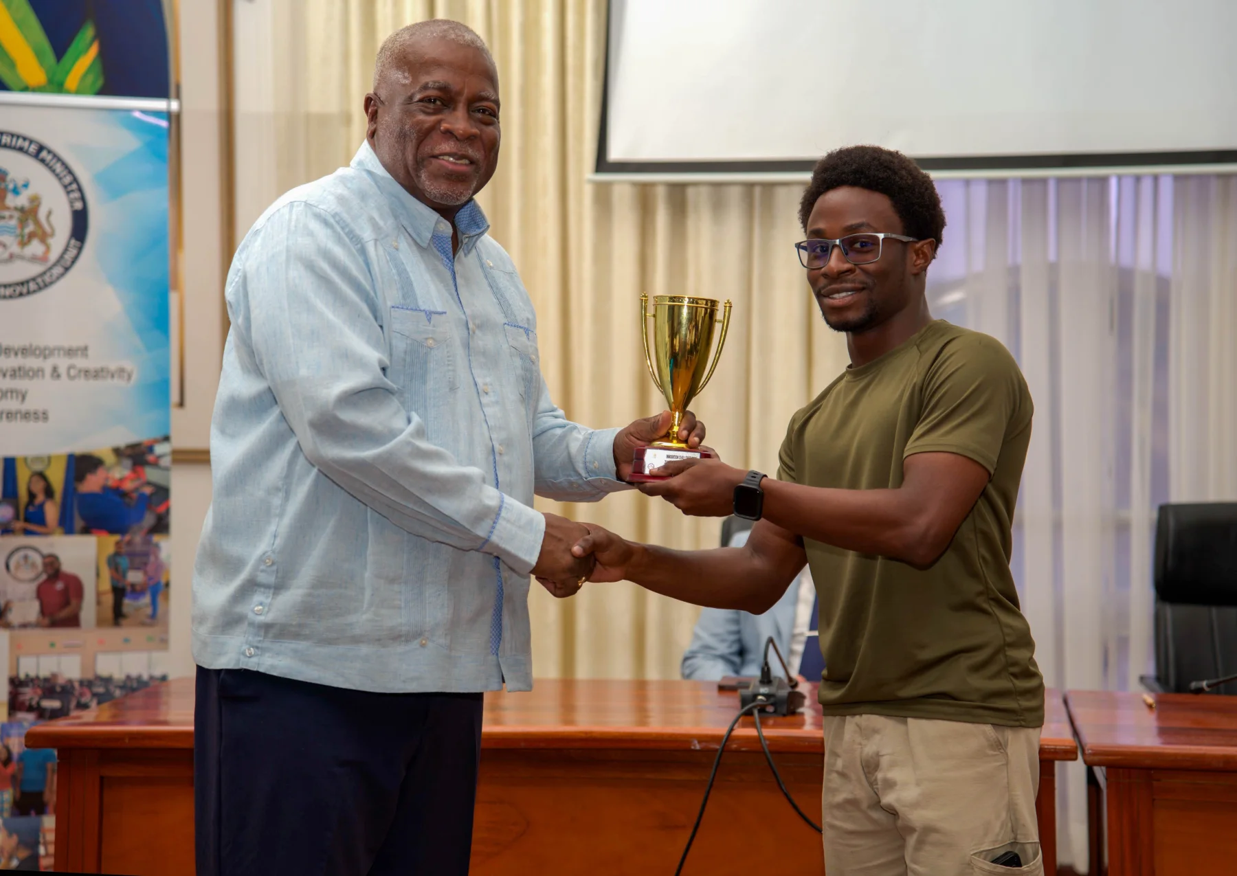 Michael receiving his hackathon trophy from the Prime Minister
