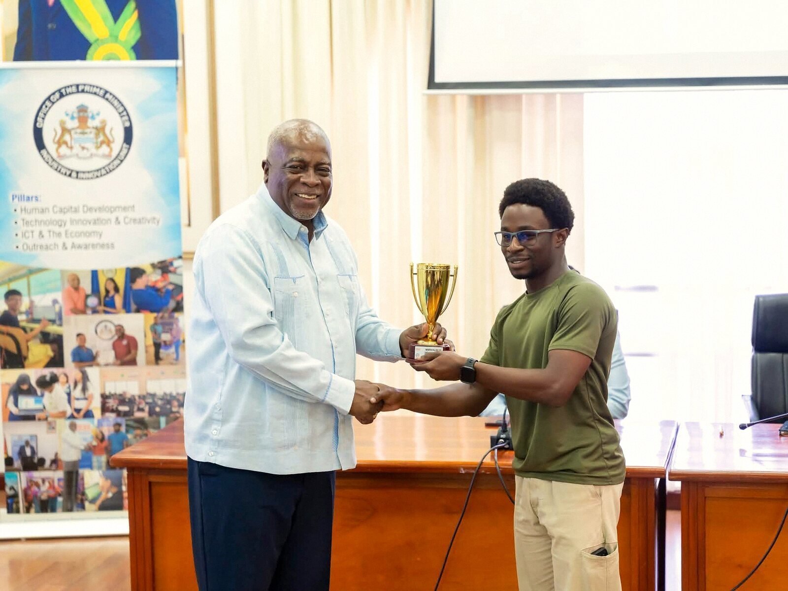 The trophy presentation with the Office of the Prime Minister banner